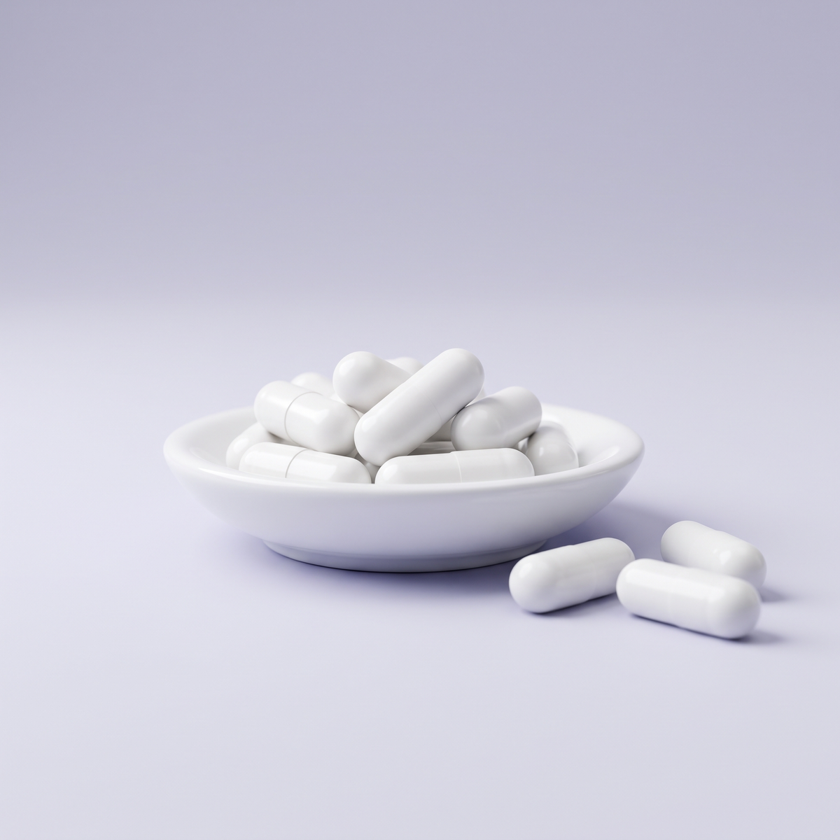 Magnesium malate capsules on a dish with a lavender gray background
